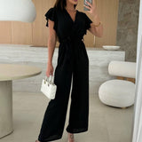 Rochelle Combinaison Femme – Élégante Combinaison Unie avec Décolleté en V, Ceinture & Jambes Amples à Volants