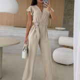 Rochelle Combinaison Femme – Élégante Combinaison Unie avec Décolleté en V, Ceinture & Jambes Amples à Volants