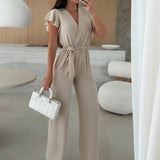 Rochelle Combinaison Femme – Élégante Combinaison Unie avec Décolleté en V, Ceinture & Jambes Amples à Volants